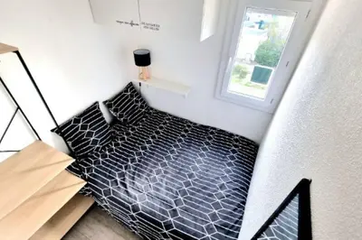 an overhead view of a bed in a small room at Appartement Iris Résidence les Grenadines in Gruissan