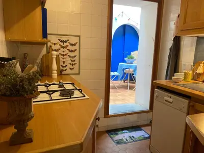a kitchen with a counter and a stove top oven at Casa Bohême in Caunes-Minervois