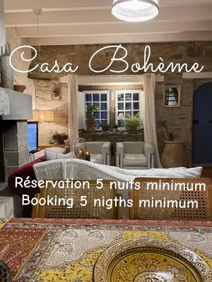 a living room with a couch and a fireplace at Casa Bohême in Caunes-Minervois
