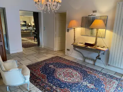 a living room with a desk and a chair and a rug at L’Hacienda Francesa in Palaja