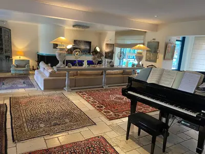 a living room with a piano and a couch at L’Hacienda Francesa in Palaja