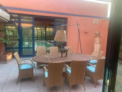 a table with chairs and a lamp on a patio at L’Hacienda Francesa in Palaja