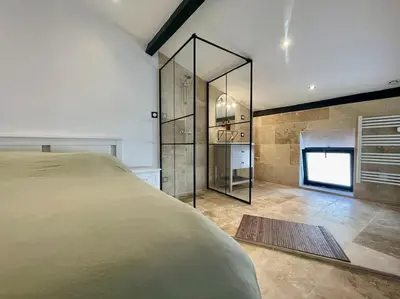 a bedroom with a bed and a large mirror at Le Saint-Jean - Cœur de La Cité Médiévale in Carcassonne