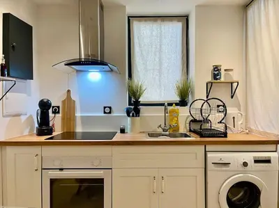 a kitchen counter with a sink and a dishwasher at Le Saint-Jean - Cœur de La Cité Médiévale in Carcassonne