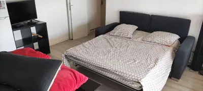 a bed with two pillows on it in a room at Appartement 4 personnes in Port-la-Nouvelle