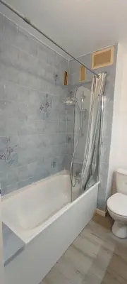 a bathroom with a shower and a tub and a toilet at Appartement 4 personnes in Port-la-Nouvelle