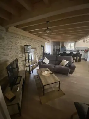 a living room with a couch and a table at La Grange du Pradel in Montredon-Labessonnié