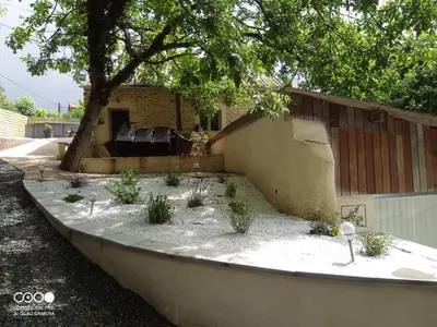 a garden with plants in front of a building at La Grange du Pradel in Montredon-Labessonnié