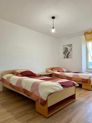 a bedroom with two beds in a room at Maison confortable - 5min de Carcassonne in Conques-sur-Orbiel