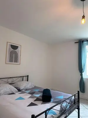 a bedroom with a bed with a checkerboard pattern on it at Maison confortable - 5min de Carcassonne in Conques-sur-Orbiel