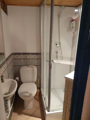 a bathroom with a shower and a toilet and a sink at Chambre d'hôte Les maisons de Gaia in Tuchan