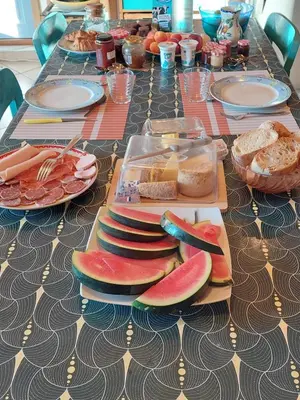 a long table with plates of food on it at Chambre d'hôte Les maisons de Gaia in Tuchan