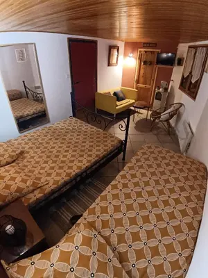 a room with two beds and a mirror at Chambre d'hôte Les maisons de Gaia in Tuchan
