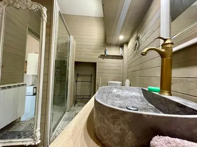 a bathroom with a sink and a faucet at Côté Cité appartements - Parking privé - 100m Cité médiévale in Carcassonne