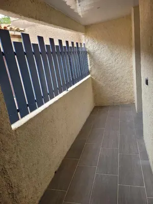 a bathroom with a shower and a sink and a mirror at Charmant T3 avec terrasse in Carcassonne