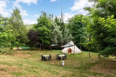 a tent and picnic tables in a field at Camping maeva Respire La Serre in Aigues-Vives