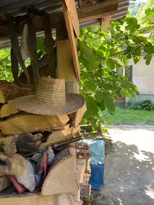 a hat sitting on top of a pile of wood at La Maison dans la forêt in Vabre