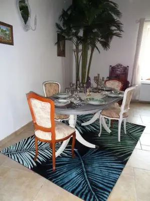 a dining room table and chairs on a rug at Château Winery la Batisse le minervois in La Redorte