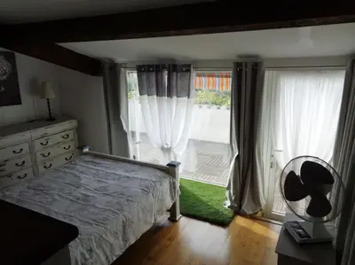 a bedroom with a bed and a large window at Château Winery la Batisse le minervois in La Redorte