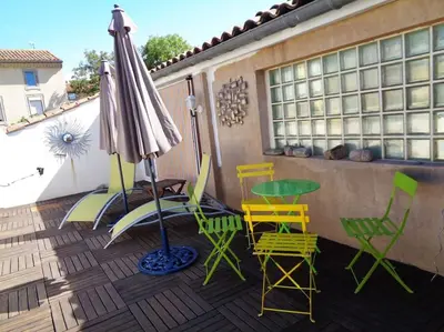 a patio with a table and chairs and an umbrella at Château Winery la Batisse le minervois in La Redorte