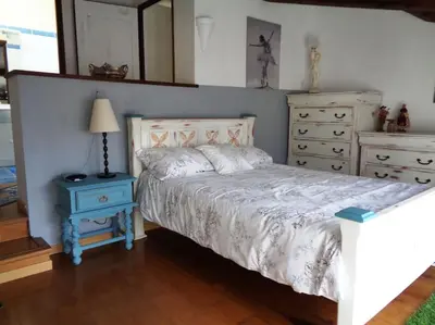 a bedroom with a bed and a dresser and a mirror at Château Winery la Batisse le minervois in La Redorte