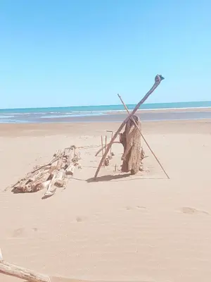 a sand sculpture of a windmill on a beach at Studio Oasis Narbonne Terrasse & Calme in Narbonne