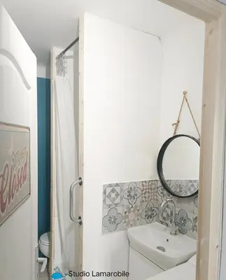 a bathroom with a sink and a toilet and a mirror at Studio Oasis Narbonne Terrasse & Calme in Narbonne
