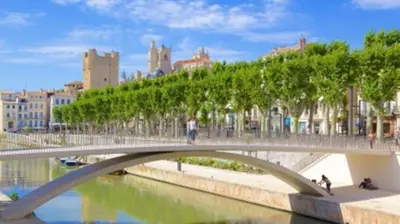 a bridge over a river with people walking on it at LE BELFORT 2 Studio lunimeux Quartier les halles in Narbonne