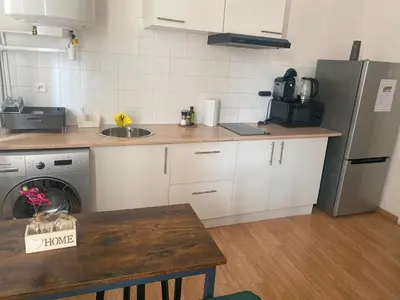 a kitchen with a sink and a refrigerator at LE BELFORT 2 Studio lunimeux Quartier les halles in Narbonne