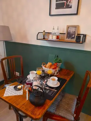 a wooden table with food and drinks on it at La maison de Mona in Carcassonne