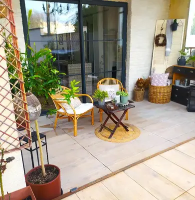 a patio with chairs and a table with plants at La maison de Mona in Carcassonne