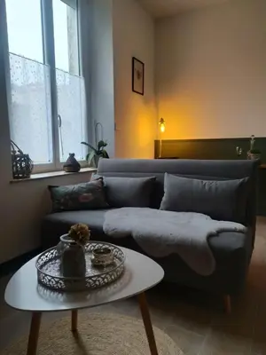 a living room with a couch and a table at La maison de Mona in Carcassonne