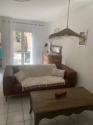 a living room with a couch and a coffee table at L'olivier de Nonna in Gruissan
