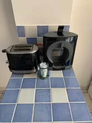 a counter top with a toaster and a coffee maker at L'olivier de Nonna in Gruissan