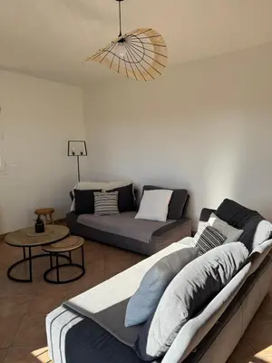 a living room with a couch and a table at Villa Tamaris in Carcassonne