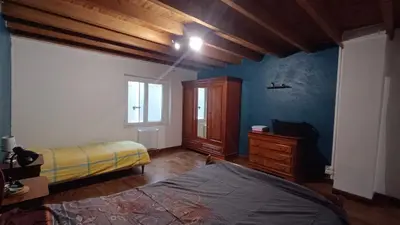 a bedroom with a bed and a dresser and a window at Charmante Maison de Village T3 Rénovée et son Jardin in Revel