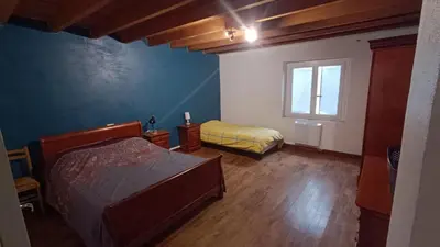 a bedroom with two beds and a window at Charmante Maison de Village T3 Rénovée et son Jardin in Revel