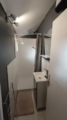 a small bathroom with a shower and a sink at Charmante Maison de Village T3 Rénovée et son Jardin in Revel
