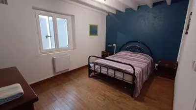 a bedroom with a bed and a window at Charmante Maison de Village T3 Rénovée et son Jardin in Revel