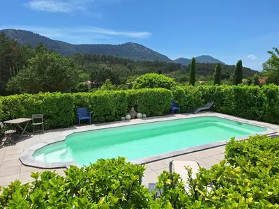 a swimming pool with a table and chairs in a yard at Villa les terre rouges avec piscine dans l ' Aude in Arques