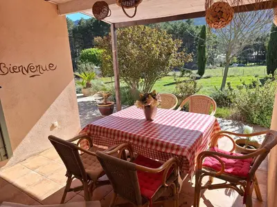 a table with chairs and a red and white checkered table cloth at Villa les terre rouges avec piscine dans l ' Aude in Arques