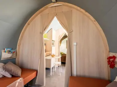a room with two desks in a room with an arched window at Camping 3 étoiles - Piscine - eehdai in Sigean