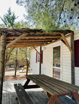 a kitchen with a table and chairs and a dining room at Camping 3 étoiles - Piscine - eehdai in Sigean