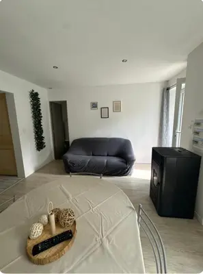 a living room with a couch and a television at Appartement T3 in Marseillette