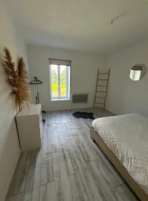a bedroom with a bed and a desk and a window at Appartement T3 in Marseillette