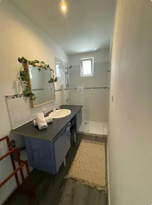 a bathroom with a sink and a mirror at Appartement T3 in Marseillette