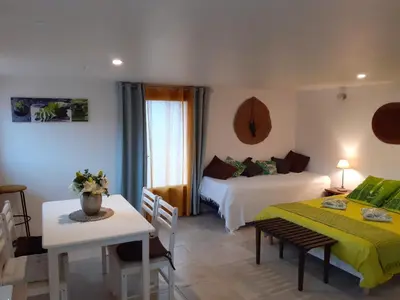 a hotel room with two beds and a table and a couch at Studio 