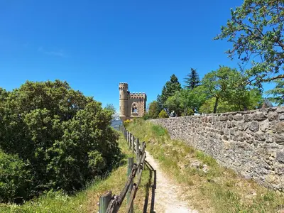 a stone wall with a gate and a castle at Studio 