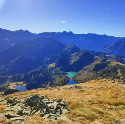 a view of a mountain with a lake in the distance at Le gîte du bonheur in Dalou
