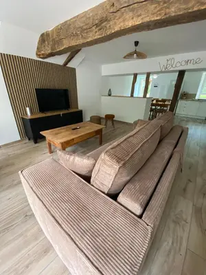 a living room with a couch and a table at Le gîte du bonheur in Dalou